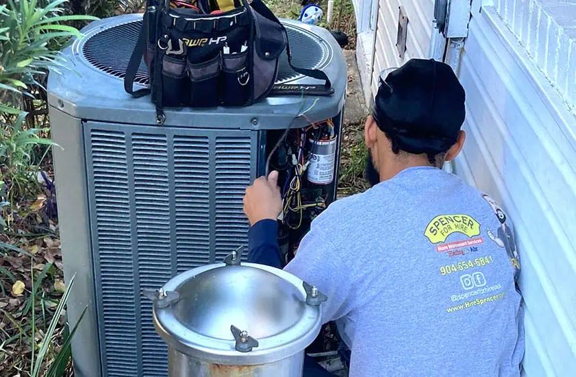 Technician servicing a condenser